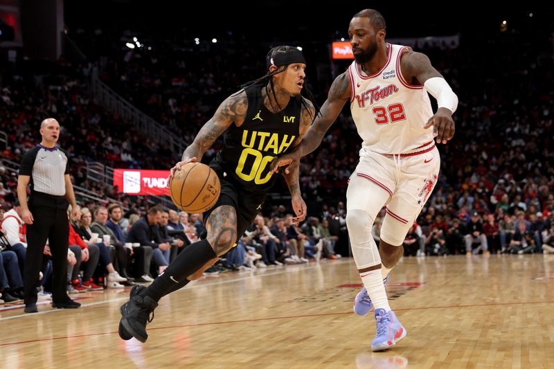 HOUSTON, TEXAS - JANUARY 20: Jordan Clarkson #00 of the Utah Jazz drives to the basket while defended by Jeff Green #32 of the Houston Rockets in the second half at Toyota Center on January 20, 2024 in Houston, Texas.  NOTE TO USER: User expressly acknowledges and agrees that, by downloading and or using this photograph, User is consenting to the terms and conditions of the Getty Images License Agreement. (Photo by Tim Warner/Getty Images)