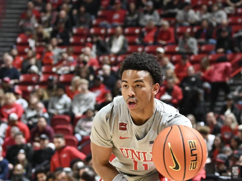 Jan 13, 2024; Las Vegas, Nevada, USA; UNLV Rebels guard Dedan Thomas Jr. (11) makes a pass against the Utah State Aggies in the first half at Thomas & Mack Center. Mandatory Credit: Candice Ward-USA TODAY Sports