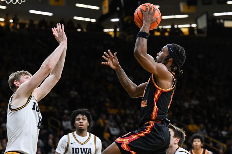 Jan 28, 2026; Iowa City, Iowa, USA; Southern California Trojans guard Kam Woods (13) goes to the basket as Iowa Hawkeyes forward Cooper Koch (8) defends during the first half at Carver-Hawkeye Arena. Mandatory Credit: Jeffrey Becker-Imagn Images
