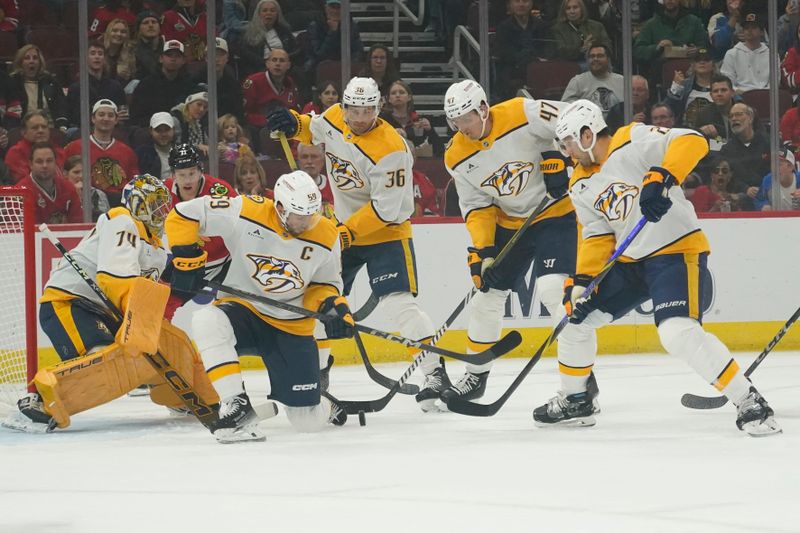 Oct 25, 2024; Chicago, Illinois, USA; The Nashville Predators clear the puck against the Chicago Blackhawks during the first period at the United Center. Mandatory Credit: David Banks-Imagn Images