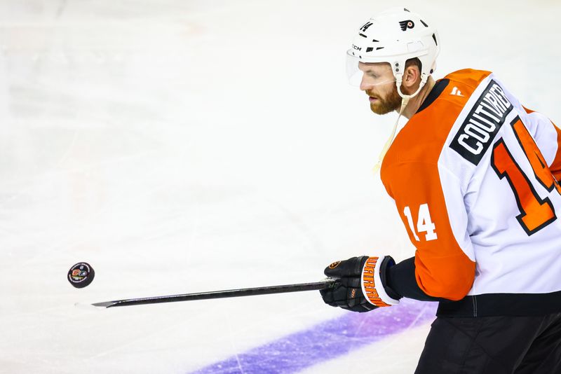 Oct 12, 2024; Calgary, Alberta, CAN; Philadelphia Flyers center Sean Couturier (14) controls the puck during the warmup period against the Calgary Flames at Scotiabank Saddledome. Mandatory Credit: Sergei Belski-Imagn Images