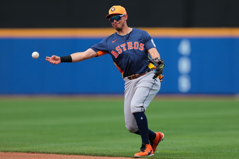 Feb 27, 2025; Port St. Lucie, Florida, USA; Houston Astros second baseman Mauricio Dubon (14) throws to first base and retires New York Mets third baseman Brett Baty (not pictured) during the fourth inning at Clover Park. Mandatory Credit: Sam Navarro-Imagn Images