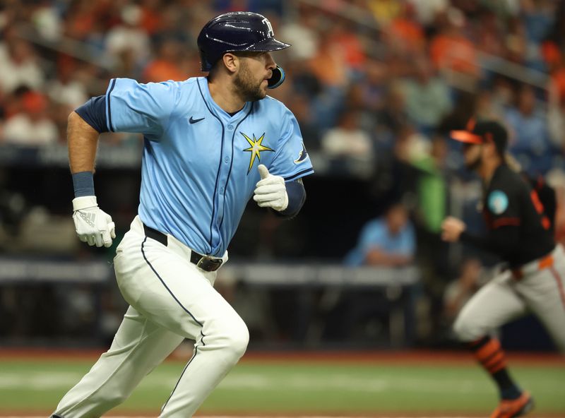 Aug 11, 2024; St. Petersburg, Florida, USA; Tampa Bay Rays outfielder Dylan Carlson (10) hits an RBI double against the Baltimore Orioles during the seventh inning  at Tropicana Field. Mandatory Credit: Kim Klement Neitzel-USA TODAY Sports