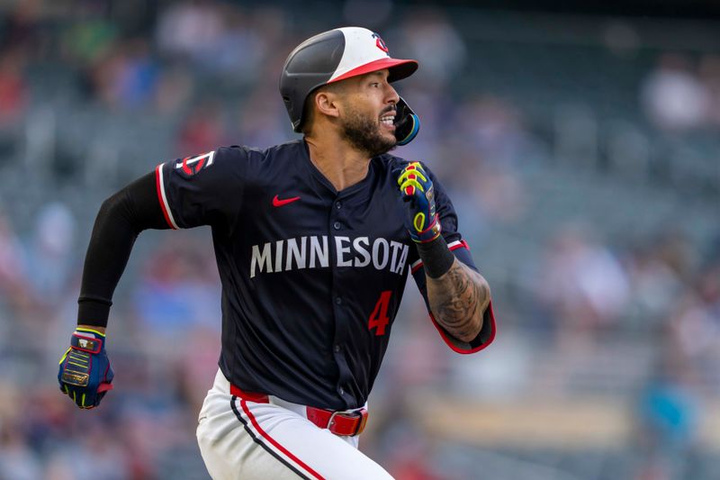 Jun 10, 2024; Minneapolis, Minnesota, USA; Minnesota Twins shortstop Carlos Correa (4) runs to first base after hitting a RBI against the Colorado Rockies in the fourth inning at Target Field. Mandatory Credit: Jesse Johnson-USA TODAY Sports