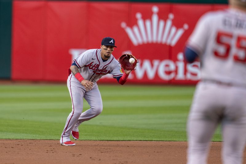 May 30, 2023; Oakland, California, USA;  Atlanta Braves shortstop Orlando Arcia (11) fields a ground ball against the Oakland Athletics during the first inning at Oakland-Alameda County Coliseum. Mandatory Credit: Neville E. Guard-USA TODAY Sports