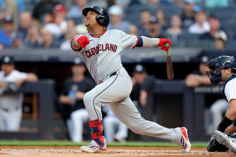 Jun 5, 2025; Bronx, New York, USA; Cleveland Guardians third baseman Jose Ramirez (11) follows through on a broken bat infield single against the New York Yankees during the first inning at Yankee Stadium. Mandatory Credit: Brad Penner-Imagn Images