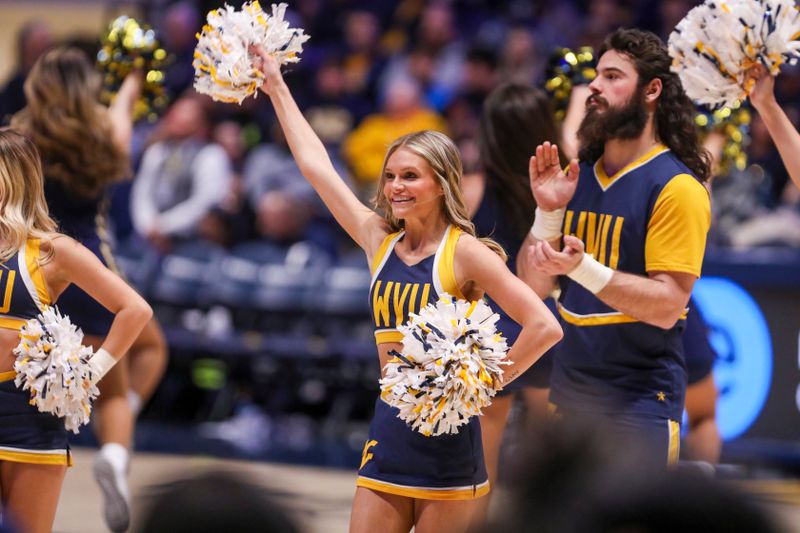 Feb 11, 2025; Morgantown, West Virginia, USA; A West Virginia Mountaineers cheerleader performs during the second half against the Brigham Young Cougars at WVU Coliseum. Mandatory Credit: Ben Queen-Imagn Images