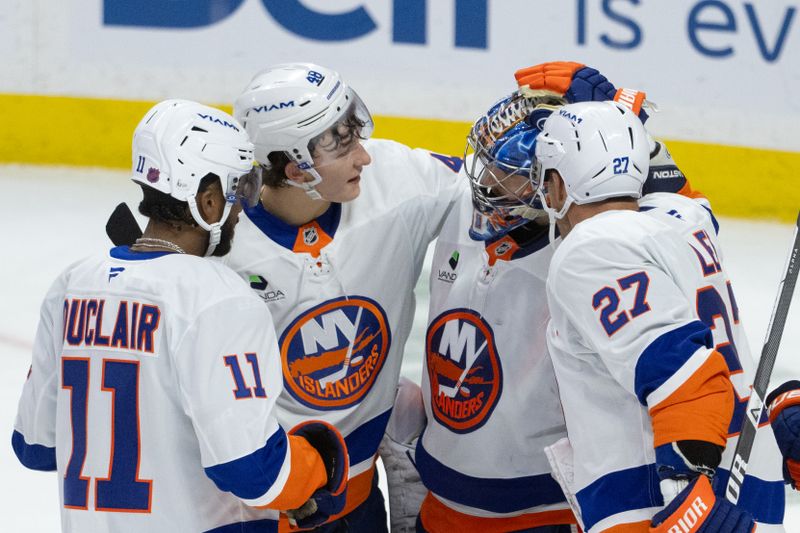 Oct 18, 2025; Ottawa, Ontario, CAN; New York Islanders left wing Anthony Duclair (11) and defenseman Matthew Schaefer (48) and left wing Anders Lee (27) congratulate their goalie Ilya Sorokin (30) following the win against the Ottawa Senators at the Canadian Tire Centre. Mandatory Credit: Marc DesRosiers-IMAGN Images