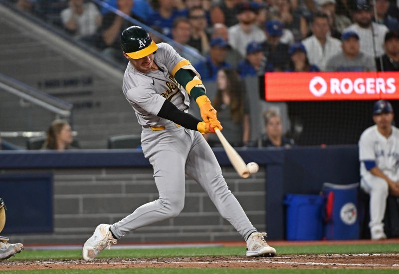 Aug 11, 2024; Toronto, Ontario, CAN; Oakland Athletics designated hitter Brent Rooker (25) hits aRBI double in the sixth inning against the Toronto Blue Jays at Rogers Centre. Mandatory Credit: Gerry Angus-USA TODAY Sports