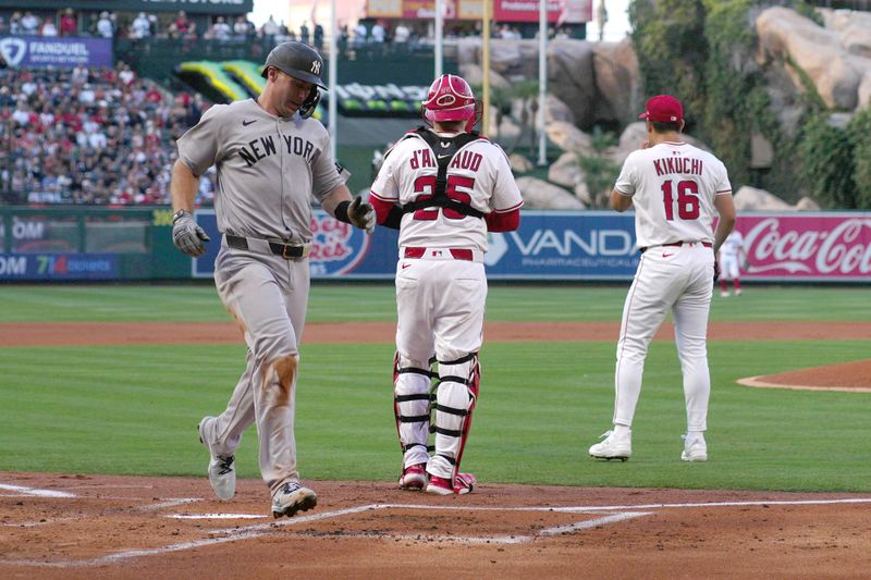 May 28, 2025; Anaheim, California, USA; New York Yankees first baseman Paul Goldschmidt (48) scores on a sacrifice fly ball in the first inning as Los Angeles Angels catcher Travis d'Arnaud (25) and starting pitcher Yusei Kikuchi (16) watch at Angel Stadium. Mandatory Credit: Kirby Lee-Imagn Images