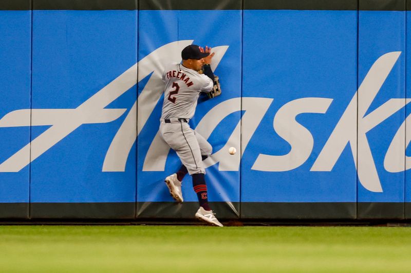 Apr 2, 2024; Seattle, Washington, USA; Cleveland Guardians center fielder Tyler Freeman (2) fails to catch a fly ball against the wall against the Seattle Mariners during the fifth inning at T-Mobile Park. Mandatory Credit: Joe Nicholson-USA TODAY Sports
