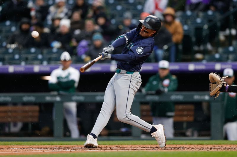 Apr 20, 2024; Denver, Colorado, USA; Seattle Mariners third baseman Josh Rojas (4) hits a single in the fourth inning against the Colorado Rockies at Coors Field. Mandatory Credit: Isaiah J. Downing-USA TODAY Sports