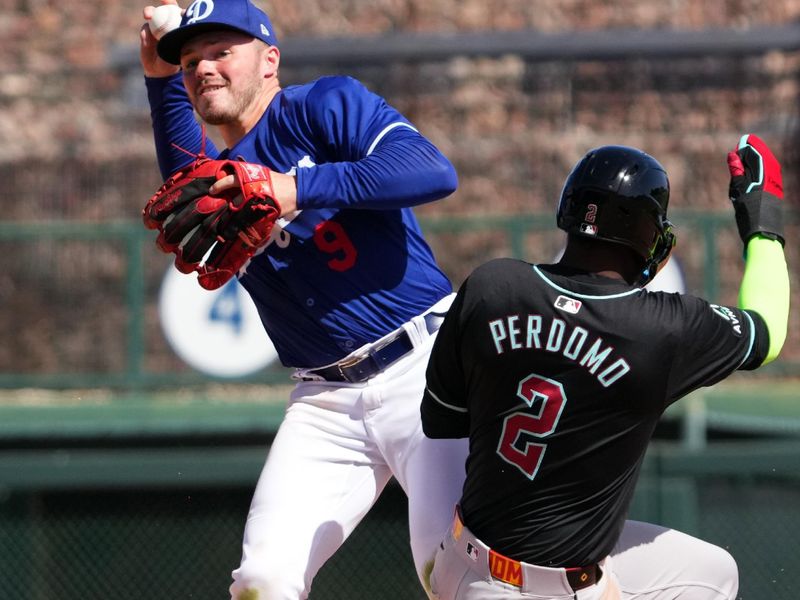 Mar 10, 2024; Phoenix, Arizona, USA; Los Angeles Dodgers shortstop Gavin Lux (9) throws to first after forcing out Arizona Diamondbacks shortstop Geraldo Perdomo (2) at second base during the fourth inning at Camelback Ranch-Glendale. Mandatory Credit: Joe Camporeale-USA TODAY Sports