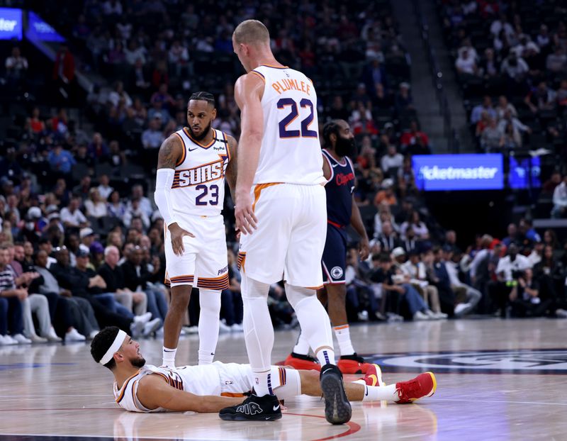 INGLEWOOD, CALIFORNIA - OCTOBER 23: Devin Booker #1 of the Phoenix Suns reacts with Mason Plumlee #22 and Monte Morris #23 of the Phoenix Suns to his foul during the first half in the season home opening game against the LA Clippers at Intuit Dome on October 23, 2024 in Inglewood, California. (Photo by Harry How/Getty Images) NOTE TO USER: User expressly acknowledges and agrees that, by downloading and or using this photograph, User is consenting to the terms and conditions of the Getty Images License Agreement. (Photo by Harry How/Getty Images)