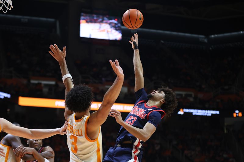 Feb 3, 2026; Knoxville, Tennessee, USA;  Mississippi Rebels guard Patton Pinkins (23) shoots the ball against Tennessee Volunteers guard Bishop Boswell (3) during the second half at Thompson-Boling Arena at Food City Center. Mandatory Credit: Randy Sartin-Imagn Images