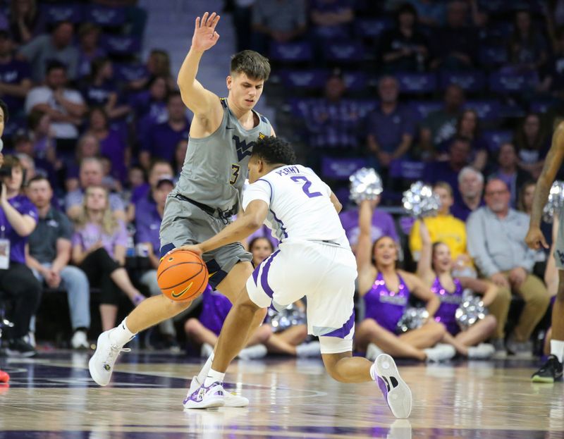 Feb 26, 2024; Manhattan, Kansas, USA; Kansas State Wildcats guard Tylor Perry (2) dribbles against West Virginia Mountaineers guard Kerr Kriisa (3) during the second half at Bramlage Coliseum. Mandatory Credit: Scott Sewell-USA TODAY Sports