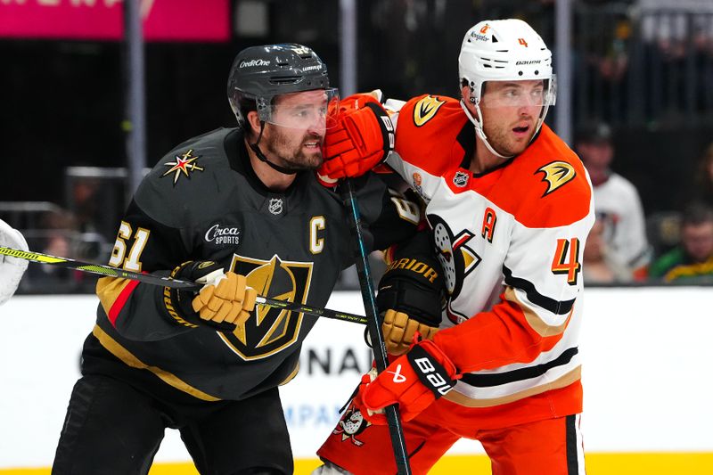 Oct 13, 2024; Las Vegas, Nevada, USA; Anaheim Ducks defenseman Cam Fowler (4) jostles with Vegas Golden Knights right wing Mark Stone (61) for position during the second period at T-Mobile Arena. Mandatory Credit: Stephen R. Sylvanie-Imagn Images