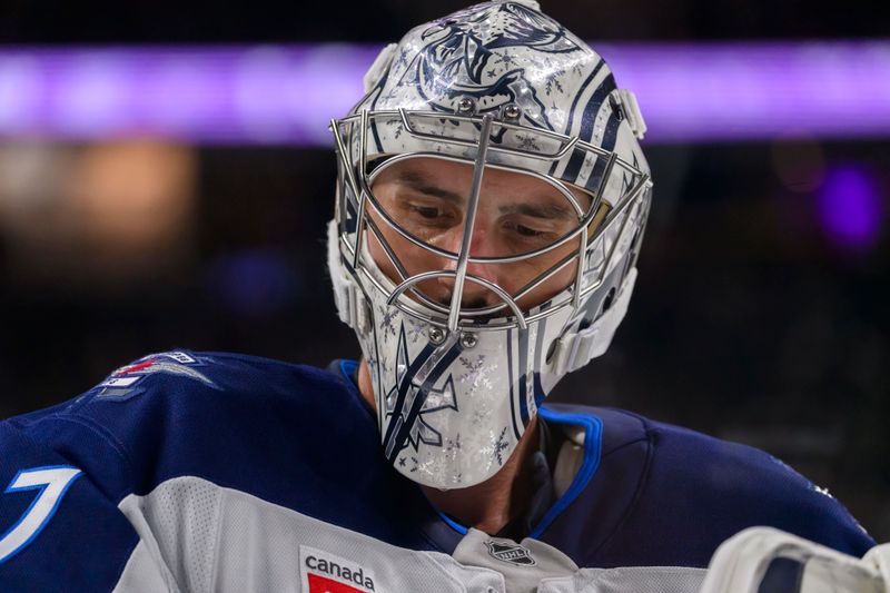 Nov 25, 2024; Saint Paul, Minnesota, USA;  Winnipeg Jets goalie Connor Hellebuyck (37) takes a breather against the Minnesota Wild during the first period at Xcel Energy Center. Mandatory Credit: Nick Wosika-Imagn Images