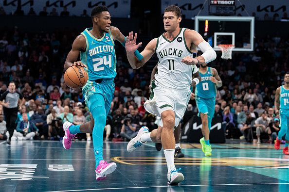 CHARLOTTE, NORTH CAROLINA - NOVEMBER 17: Brook Lopez #11 of the Milwaukee Bucks guards Brandon Miller #24 of the Charlotte Hornets in the third quarter during an NBA In-Season Tournament game at Spectrum Center on November 17, 2023 in Charlotte, North Carolina. NOTE TO USER: User expressly acknowledges and agrees that, by downloading and or using this photograph, User is consenting to the terms and conditions of the Getty Images License Agreement. (Photo by Jacob Kupferman/Getty Images)