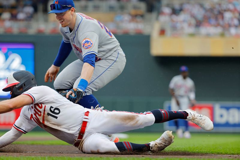 Sep 9, 2023; Minneapolis, Minnesota, USA; New York Mets third baseman Brett Baty (22) tags out Minnesota Twins third baseman Kyle Farmer (12) who gets caught in a run-down at third base in the sixth inning at Target Field. Mandatory Credit: Bruce Kluckhohn-USA TODAY Sports