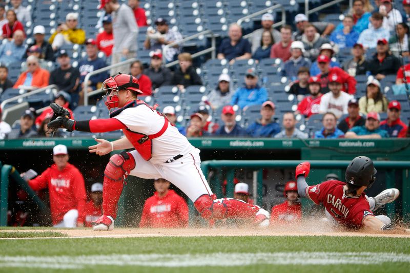 Jun 22, 2023; Washington, District of Columbia, USA; Arizona Diamondbacks left fielder Corbin Carroll (7) scores a run past Washington Nationals catcher Riley Adams (15) during the first inning at Nationals Park. Mandatory Credit: Amber Searls-USA TODAY Sports