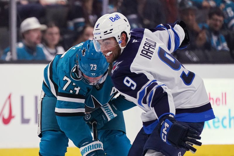 Nov 7, 2025; San Jose, California, USA; Winnipeg Jets left winger Alex Iafallo (9) vies for the puck against San Jose Sharks center Tyler Toffoli (73) during the first period at SAP Center at San Jose. Mandatory Credit: David Gonzales-Imagn Images