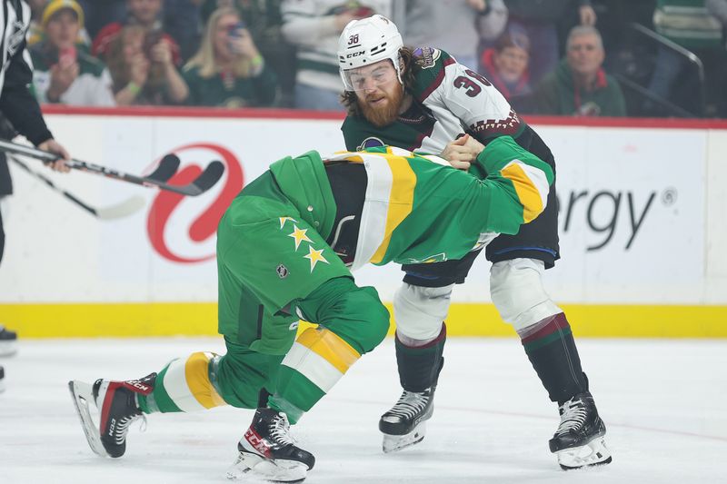 Jan 13, 2024; Saint Paul, Minnesota, USA; Minnesota Wild right wing Brandon Duhaime (21) and Arizona Coyotes center Liam O'Brien (38) fight during the first period at Xcel Energy Center. Mandatory Credit: Matt Krohn-USA TODAY Sports