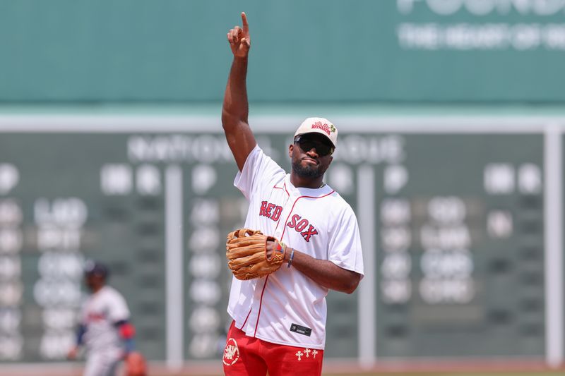 Jun 5, 2024; Boston, Massachusetts, USA; New England Patriots linebacker Joshua Uche throws out the first pitch before a game between the Atlanta Braves and the Boston Red Sox at Fenway Park. Mandatory Credit: Paul Rutherford-USA TODAY Sports