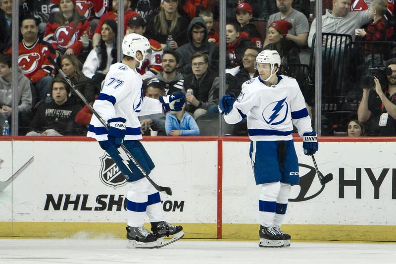 Feb 25, 2024; Newark, New Jersey, USA; Tampa Bay Lightning center Brayden Point (21) celebrates with Tampa Bay Lightning defenseman Victor Hedman (77) after scoring a goal against the New Jersey Devils during the second period at Prudential Center. Mandatory Credit: John Jones-USA TODAY Sports