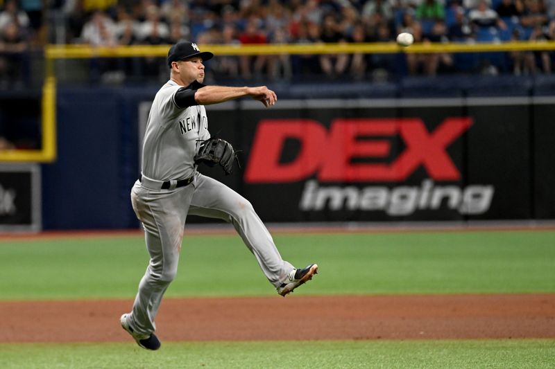 Aug 26, 2023; St. Petersburg, Florida, USA; New York Yankees third baseman Isiah Kiner-Falefa (12) throws to first base against the Tampa Bay Rays in the fourth inning at Tropicana Field. Mandatory Credit: Jonathan Dyer-USA TODAY Sports