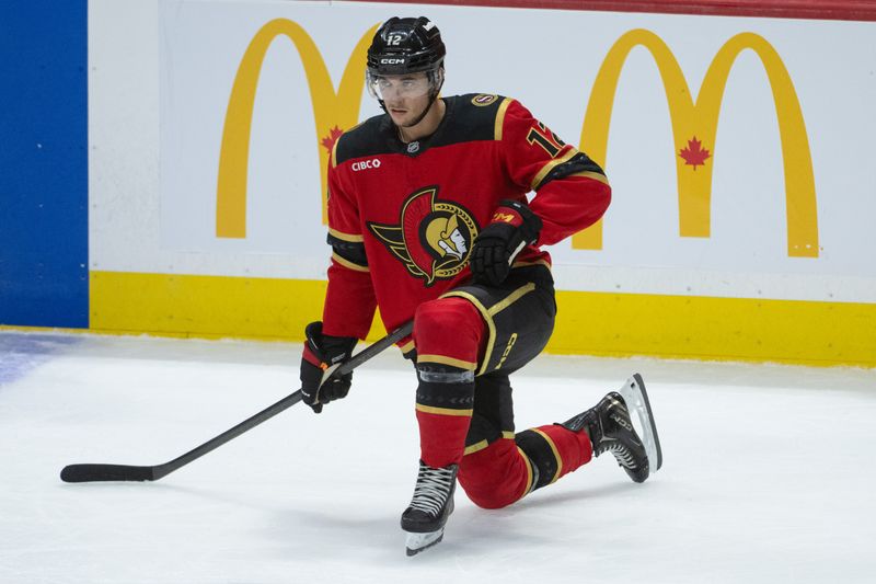 Oct 16, 2025; Ottawa, Ontario, CAN; Ottawa Senators center Shane Pinto (12) stretches prior to the start of overtime in game against the Seattle Kraken at the Canadian Tire Centre. Mandatory Credit: Marc DesRosiers-IMAGN Images