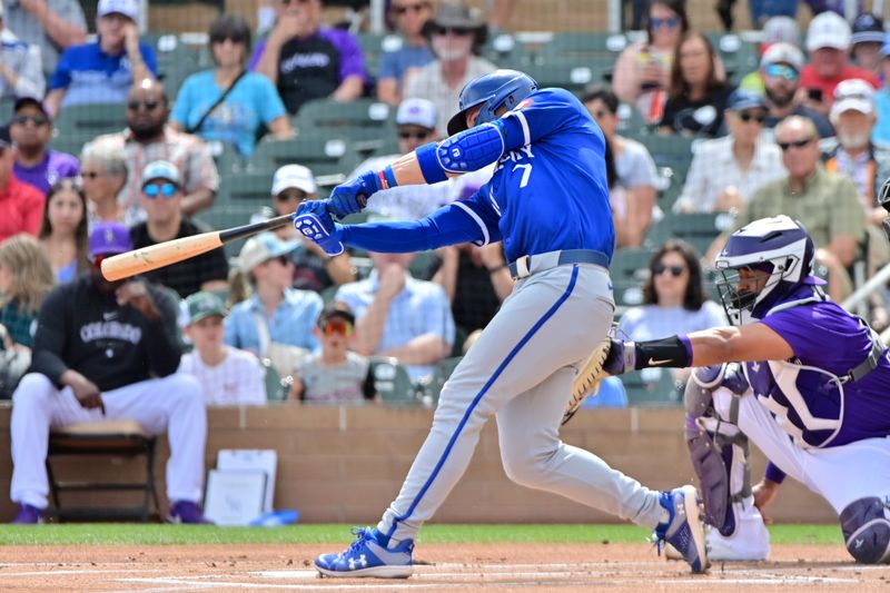 Mar 12, 2024; Salt River Pima-Maricopa, Arizona, USA;  Kansas City Royals shortstop Bobby Witt Jr. (7) singles in the first inning against the Colorado Rockies during a spring training game at Salt River Fields at Talking Stick. Mandatory Credit: Matt Kartozian-USA TODAY Sports