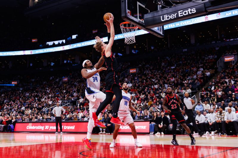 TORONTO, CANADA - JANUARY 3: Gradey Dick #1 of the Toronto Raptors goes up for a slam dunk against Wendell Carter Jr. #34 of the Orlando Magic during second half of their NBA game at Scotiabank Arena on January 3, 2025 in Toronto, Canada. NOTE TO USER: User expressly acknowledges and agrees that, by downloading and or using this photograph, User is consenting to the terms and conditions of the Getty Images License Agreement. (Photo by Cole Burston/Getty Images)