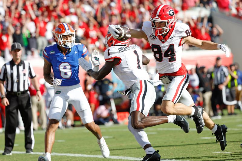 Oct 28, 2023; Jacksonville, Florida, USA; Georgia Bulldogs wide receiver Ladd McConkey (84) stretches for a touchdown against the Georgia Bulldogs in the first half at EverBank Stadium. Mandatory Credit: Jeff Swinger-USA TODAY Sports