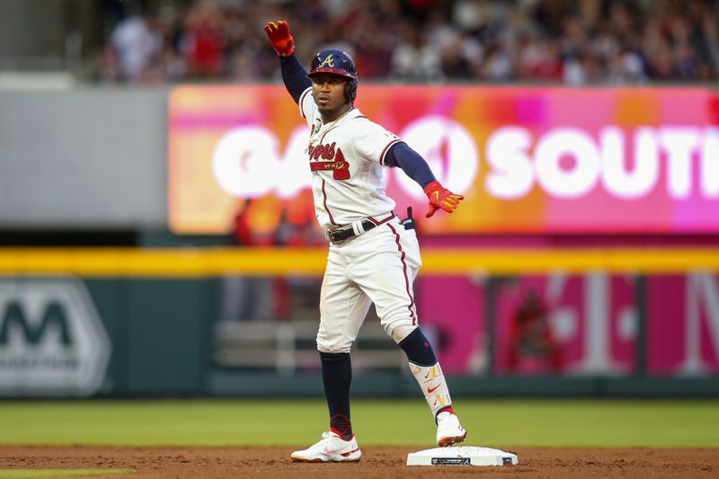Apr 11, 2022; Atlanta, Georgia, USA; Atlanta Braves second baseman Ozzie Albies (1) celebrates after hitting a single against the Washington Nationals in the first inning at Truist Park. Mandatory Credit: Brett Davis-USA TODAY Sports