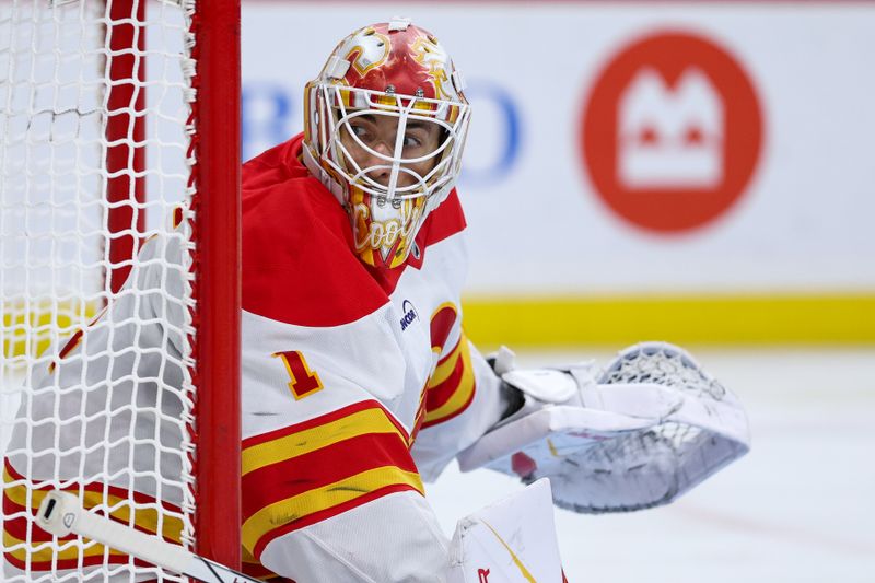 Nov 9, 2025; Saint Paul, Minnesota, USA; Calgary Flames goaltender Devin Cooley (1) defends his net against the Minnesota Wild during the second period at Grand Casino Arena. Mandatory Credit: Matt Krohn-Imagn Images