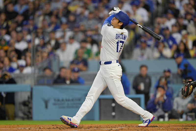 May 15, 2025; Los Angeles, California, USA; Los Angeles Dodgers designated hitter Shohei Ohtani (17) hits a sacrifice fly against the Athletics during the second inning of the game at Dodger Stadium. Mandatory Credit: Jayne Kamin-Oncea-Imagn Images