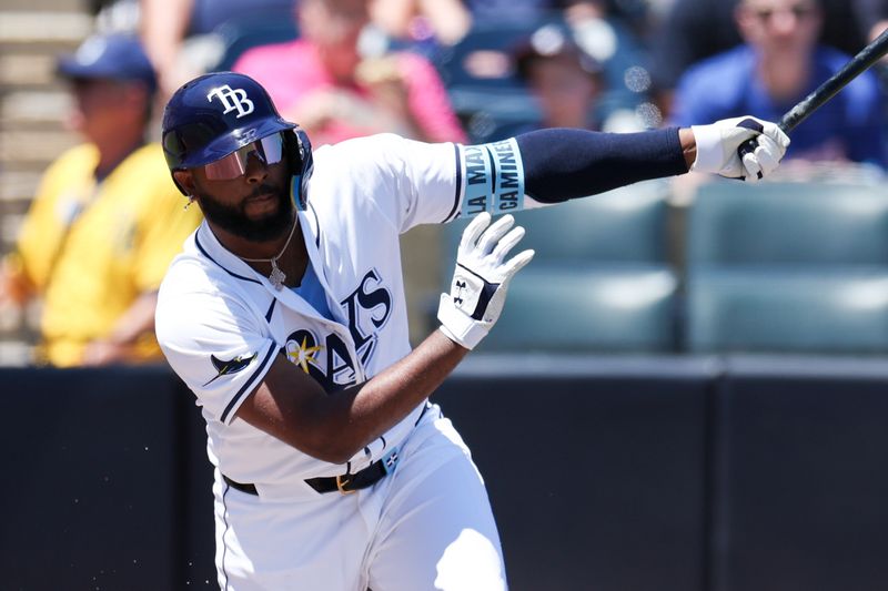 Apr 13, 2025; Tampa, Florida, USA; Tampa Bay Rays third baseman Junior Caminero (13) hits a base hit against the Atlanta Braves in the first inning at George M. Steinbrenner Field. Mandatory Credit: Nathan Ray Seebeck-Imagn Images