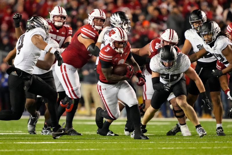 Nov 16, 2024; Madison, Wisconsin, USA;  Wisconsin Badgers running back Tawee Walker (3) rushes with the football during the third quarter against the Oregon Ducks at Camp Randall Stadium. Mandatory Credit: Jeff Hanisch-Imagn Images