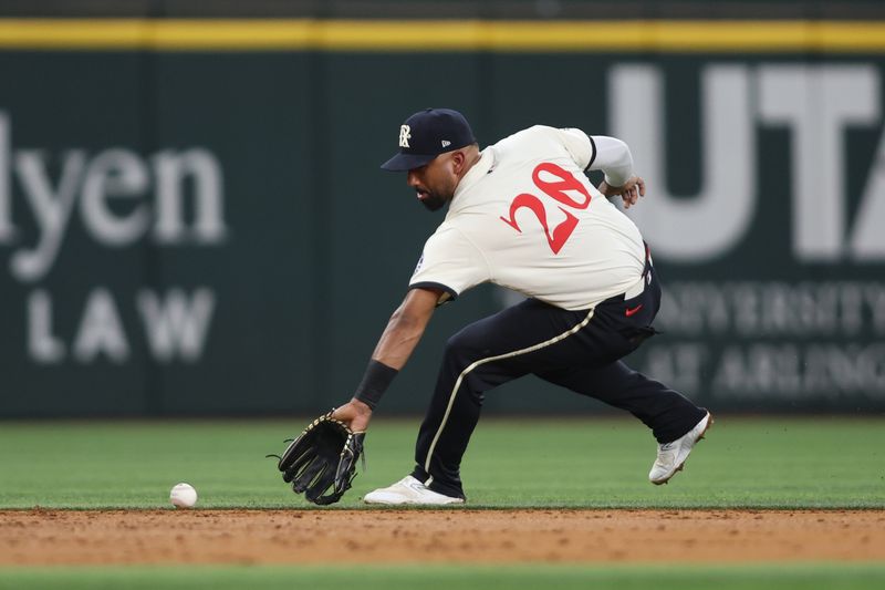 Aug 30, 2024; Arlington, Texas, USA; Texas Rangers shortstop Ezequiel Duran (20) fields a ground ball against the Oakland Athletics in the third inning at Globe Life Field. Mandatory Credit: Tim Heitman-USA TODAY Sports