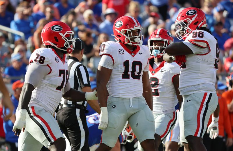 Oct 28, 2023; Jacksonville, Florida, USA; Georgia Bulldogs linebacker Jamon Dumas-Johnson (10) celebrates with teammates after sacking Florida Gators quarterback Graham Mertz (not pictured) during the first half at EverBank Stadium. Mandatory Credit: Kim Klement Neitzel-USA TODAY Sports