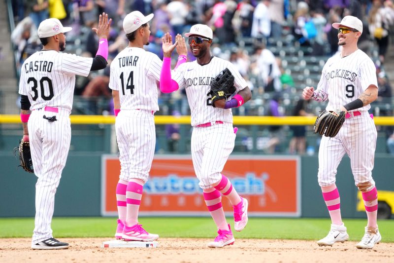 May 14, 2023; Denver, Colorado, USA; Colorado Rockies second baseman Harold Castro (30), shortstop Ezequiel Tovar (14),left fielder Jurickson Profar (29) and center fielder Brenton Doyle (9) celebrate defeating the the Philadelphia Phillies in the ninth inning at Coors Field. Mandatory Credit: Ron Chenoy-USA TODAY Sports