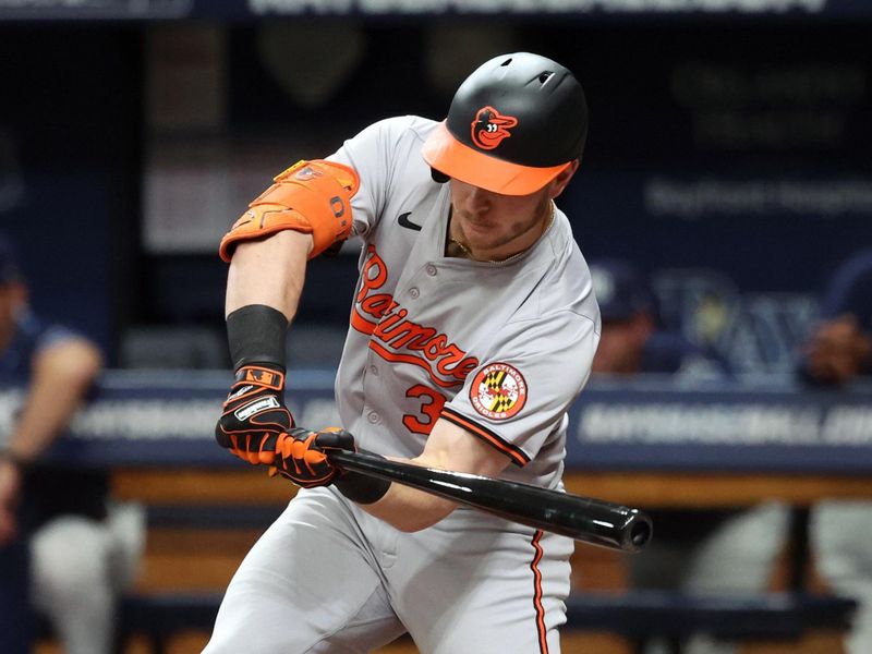 Jun 10, 2024; St. Petersburg, Florida, USA;  Baltimore Orioles first base Ryan O'Hearn (32) singles against the Tampa Bay Rays during the first inning at Tropicana Field. Mandatory Credit: Kim Klement Neitzel-USA TODAY Sports