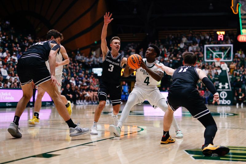 Feb 4, 2023; Fort Collins, Colorado, USA; Colorado State Rams guard Isaiah Stevens (4) controls the ball under pressure from Utah State Aggies guard Steven Ashworth (3) and guard Max Shulga (11) and center Trevin Dorius (32) in the second half at Moby Arena. Mandatory Credit: Isaiah J. Downing-USA TODAY Sports