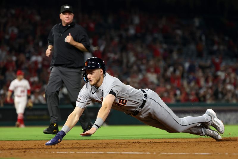 Sep 16, 2023; Anaheim, California, USA;  Detroit Tigers center fielder Parker Meadows (22) dives back to the first base on fly ball by third baseman Tyler Nevin (18) during the tenth inning against the Los Angeles Angels at Angel Stadium. Mandatory Credit: Kiyoshi Mio-USA TODAY Sports