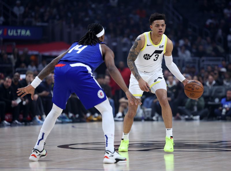 LOS ANGELES, CALIFORNIA - APRIL 12: Keyonte George #3 of the Utah Jazz dribbles in front of Terance Mann #14 of the LA Clippers during a 110-109 Jazz win at Crypto.com Arena on April 12, 2024 in Los Angeles, California. User is consenting to the terms and conditions of the Getty Images License Agreement.  (Photo by Harry How/Getty Images)