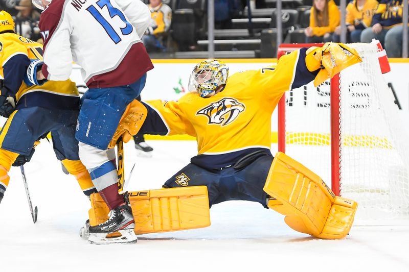 Nov 20, 2023; Nashville, Tennessee, USA; Nashville Predators goaltender Juuse Saros (74) makes a diving backwards glove save against the Colorado Avalanche during the second period at Bridgestone Arena. Mandatory Credit: Steve Roberts-USA TODAY Sports