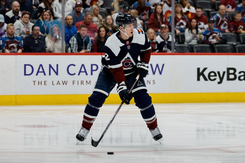 Apr 13, 2024; Denver, Colorado, USA; Colorado Avalanche defenseman Josh Manson (42) controls the puck in the first period against the Winnipeg Jets at Ball Arena. Mandatory Credit: Isaiah J. Downing-USA TODAY Sports