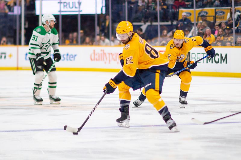 Feb 15, 2024; Nashville, Tennessee, USA; Nashville Predators center Tommy Novak (82) skates with the puck against the Dallas Stars during the third period at Bridgestone Arena. Mandatory Credit: Steve Roberts-USA TODAY Sports