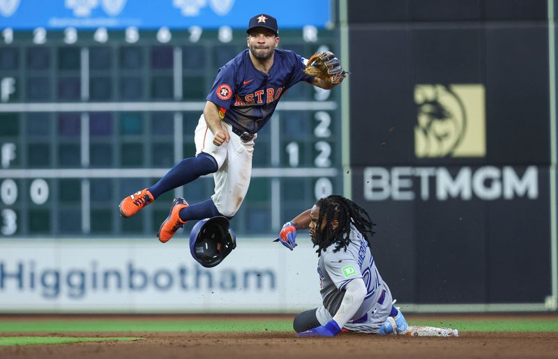 Apr 2, 2024; Houston, Texas, USA; Toronto Blue Jays first baseman Vladimir Guerrero Jr. (27) is out as Houston Astros second baseman Jose Altuve (27) leaps to complete a double play during the ninth inning at Minute Maid Park. Mandatory Credit: Troy Taormina-USA TODAY Sports